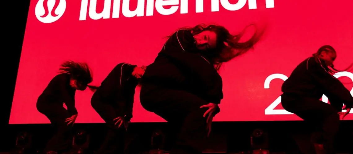 Professional dancers from Stadium Dance performing for a live corporate event program on a ballroom stage.
